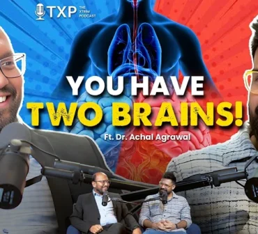 Podcast episode poster featuring two men at microphones with a blue and red human anatomy graphic, large bold text "YOU HAVE TWO BRAINS! Ft. Dr. Achal Agrawal," and the TXP podcast logo.