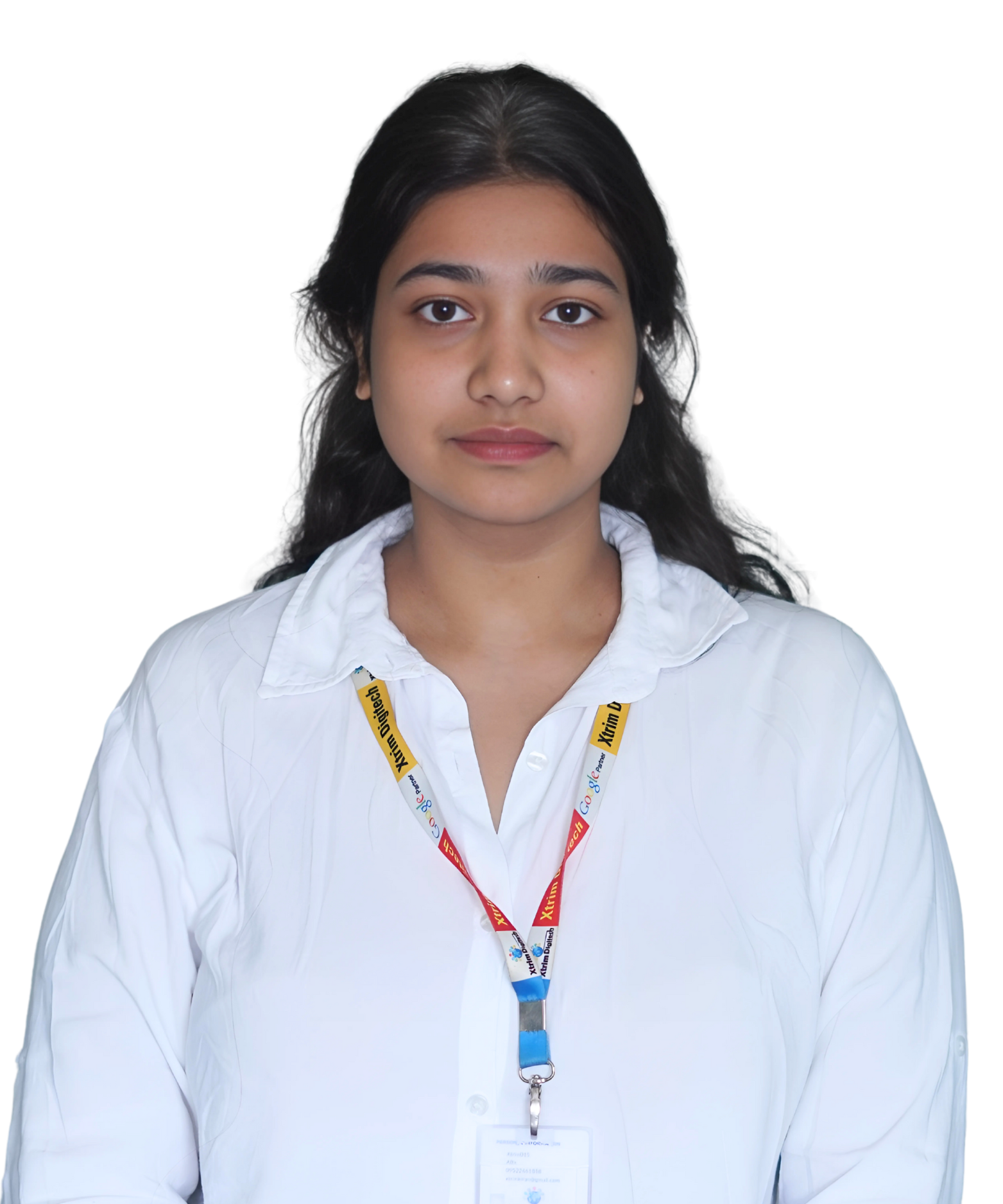 A person named Taniya, wearing a white striped shirt, standing and looking directly at the camera with a subtle smile. Taniya is a member of the Xtrim Digitech team.