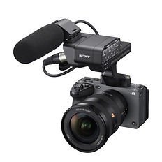 Sony Alpha camera with a lens and a large shotgun microphone attached on top, displayed against a white background.