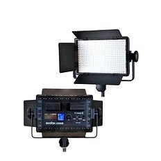 Two views of a Godox LED video lighting panel with barn doors, showing both the illuminated front grid and the detailed back controls.